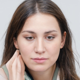 Neutral white young-adult female with long  brown hair and brown eyes