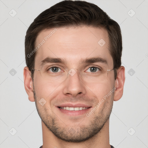 Joyful white young-adult male with short  brown hair and grey eyes