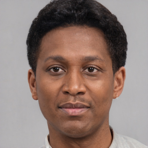 Joyful latino young-adult male with short  brown hair and brown eyes