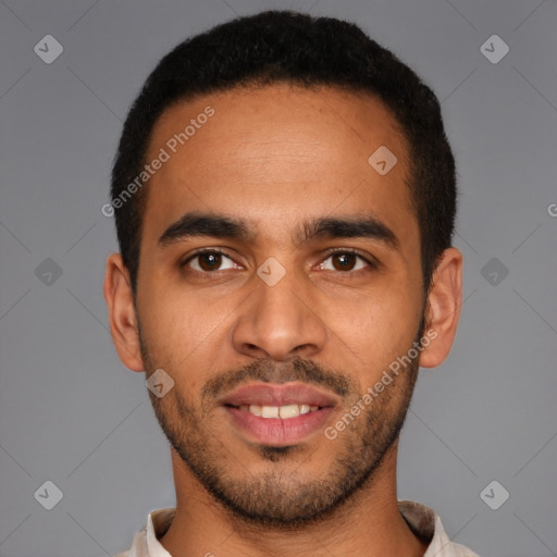 Joyful latino young-adult male with short  brown hair and brown eyes