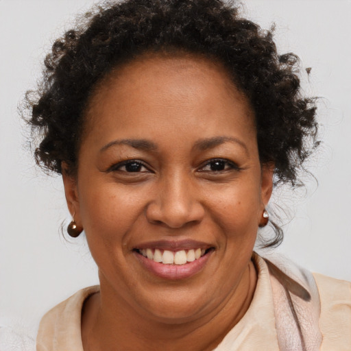 Joyful black adult female with short  brown hair and brown eyes