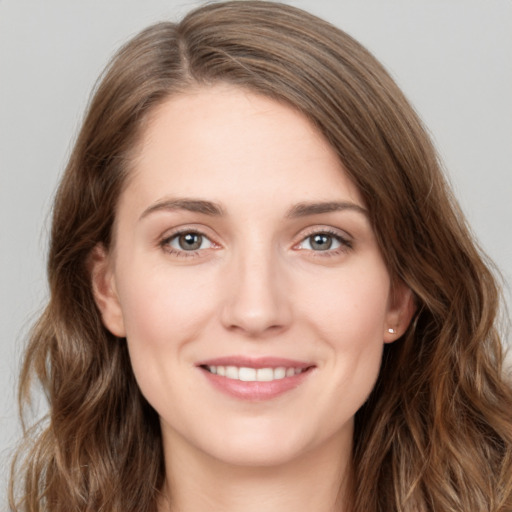 Joyful white young-adult female with long  brown hair and green eyes