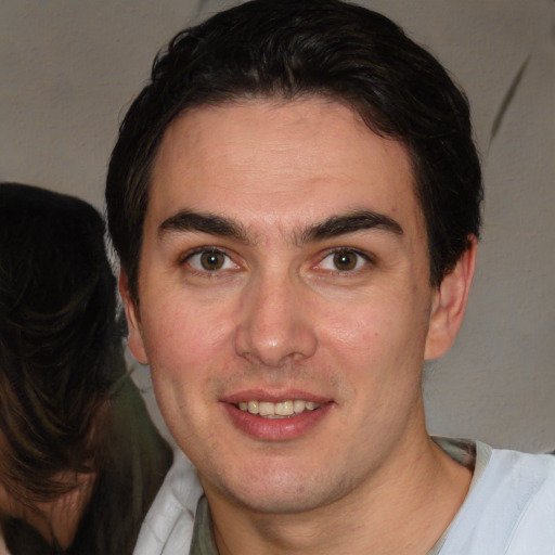 Joyful white young-adult male with short  brown hair and brown eyes