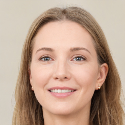 Joyful white young-adult female with long  brown hair and grey eyes