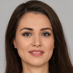 Joyful white young-adult female with long  brown hair and brown eyes