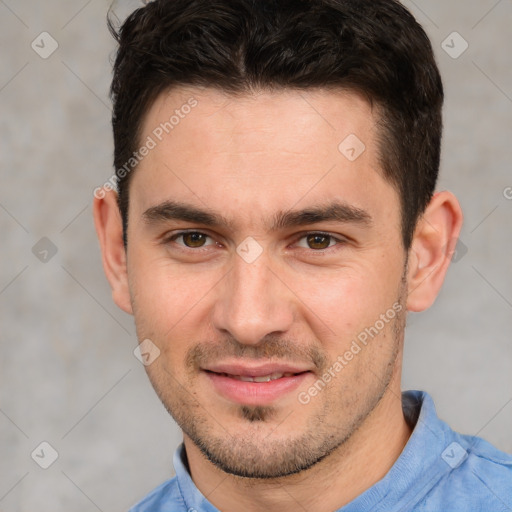 Joyful white young-adult male with short  brown hair and brown eyes