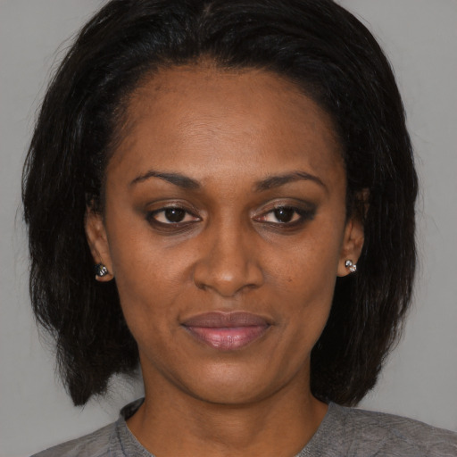 Joyful asian adult female with medium  brown hair and brown eyes