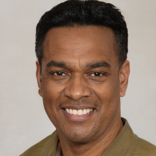 Joyful latino adult male with short  black hair and brown eyes