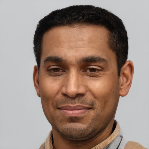 Joyful latino young-adult male with short  black hair and brown eyes
