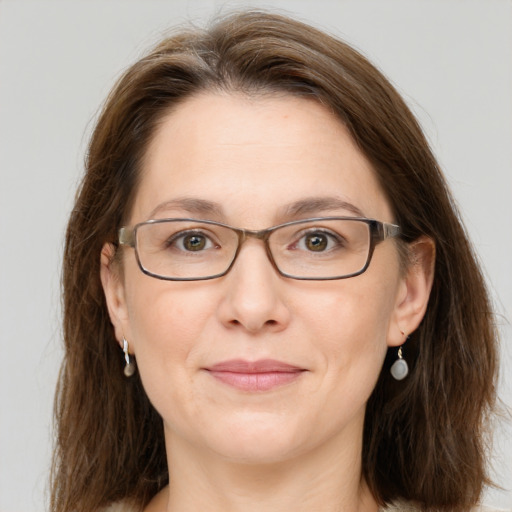 Joyful white adult female with long  brown hair and grey eyes