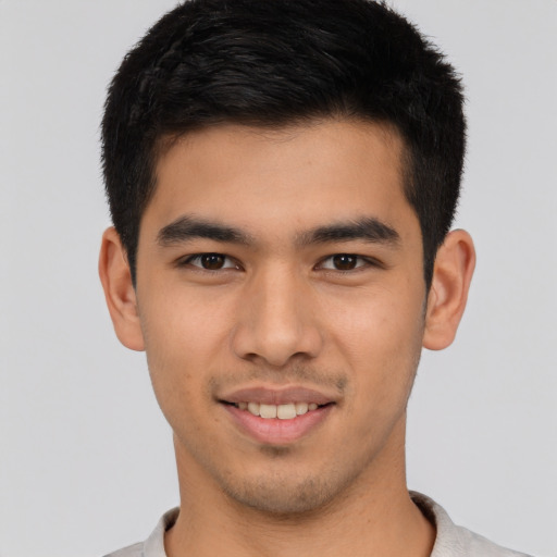 Joyful asian young-adult male with short  brown hair and brown eyes