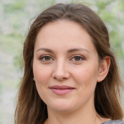 Joyful white young-adult female with medium  brown hair and green eyes