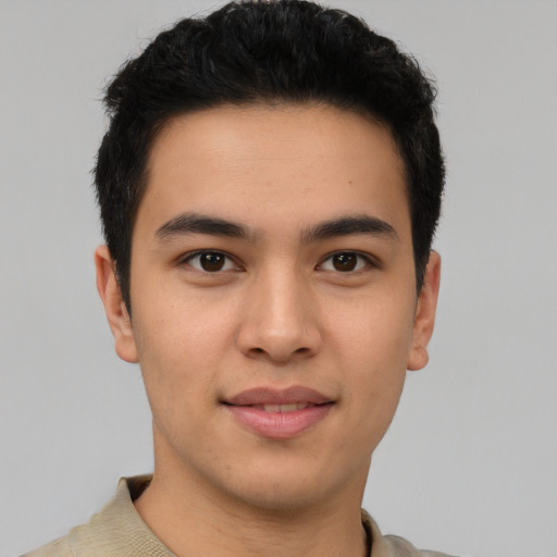 Joyful latino young-adult male with short  brown hair and brown eyes