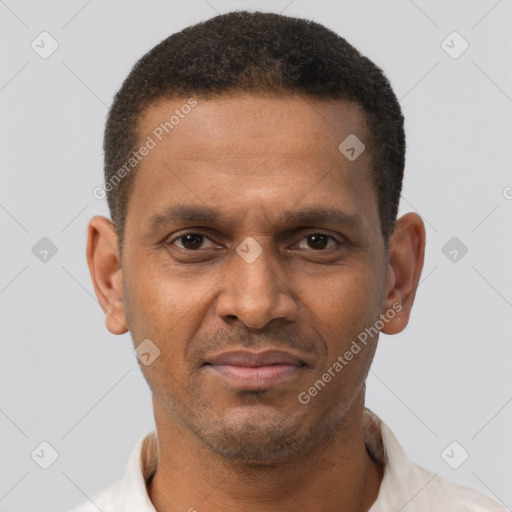 Joyful black young-adult male with short  brown hair and brown eyes