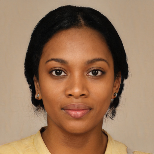 Joyful black young-adult female with short  black hair and brown eyes