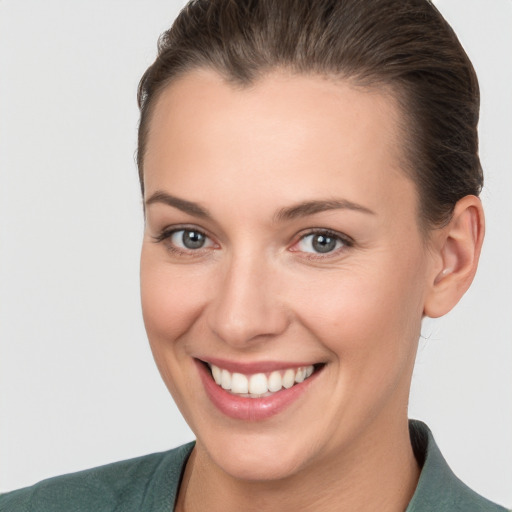 Joyful white young-adult female with short  brown hair and brown eyes