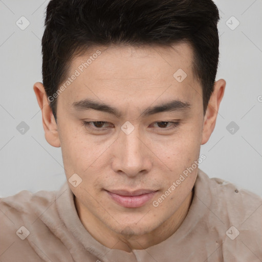 Joyful asian young-adult male with short  brown hair and brown eyes