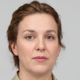 Joyful white adult female with medium  brown hair and grey eyes