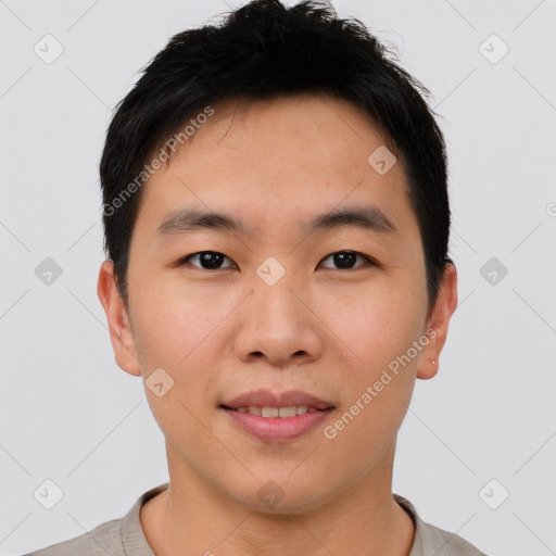 Joyful asian young-adult male with short  brown hair and brown eyes