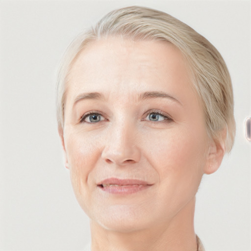 Joyful white adult female with short  blond hair and grey eyes