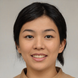 Joyful asian young-adult female with medium  black hair and brown eyes