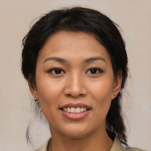 Joyful asian young-adult female with medium  brown hair and brown eyes