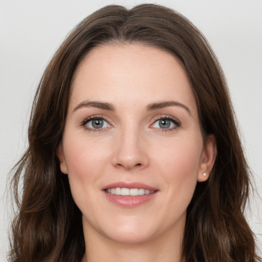 Joyful white young-adult female with long  brown hair and grey eyes