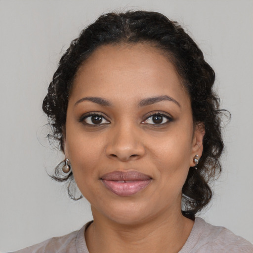 Joyful black young-adult female with medium  black hair and brown eyes