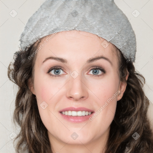 Joyful white young-adult female with medium  brown hair and blue eyes