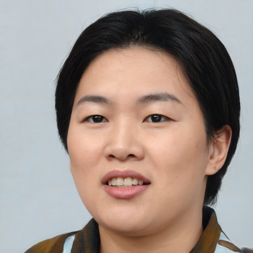 Joyful asian young-adult female with medium  black hair and brown eyes
