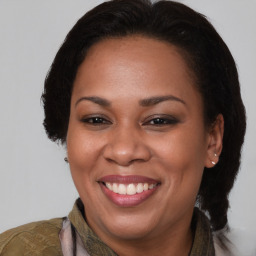 Joyful latino adult female with medium  brown hair and brown eyes