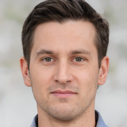 Joyful white adult male with short  brown hair and grey eyes