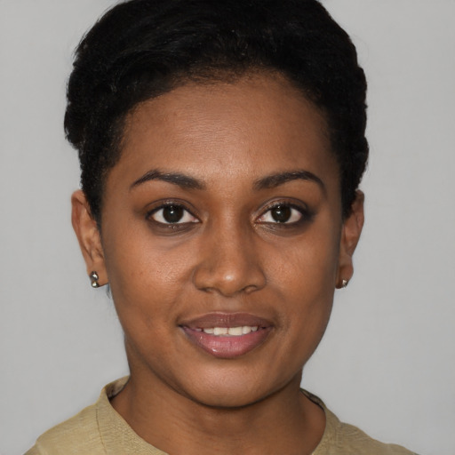 Joyful black young-adult female with short  black hair and brown eyes