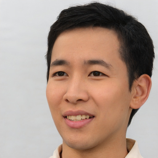 Joyful asian young-adult male with short  black hair and brown eyes