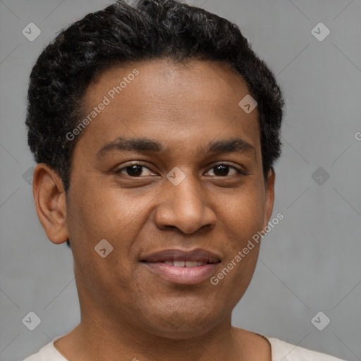 Joyful black young-adult male with short  brown hair and brown eyes