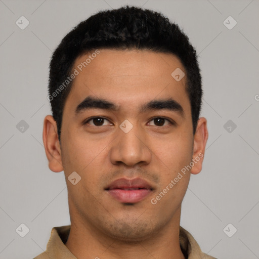 Joyful latino young-adult male with short  black hair and brown eyes