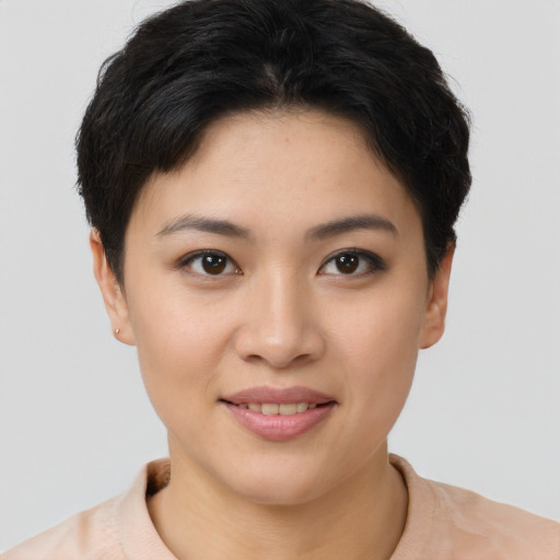 Joyful asian young-adult female with short  brown hair and brown eyes