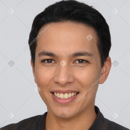 Joyful white young-adult male with short  black hair and brown eyes