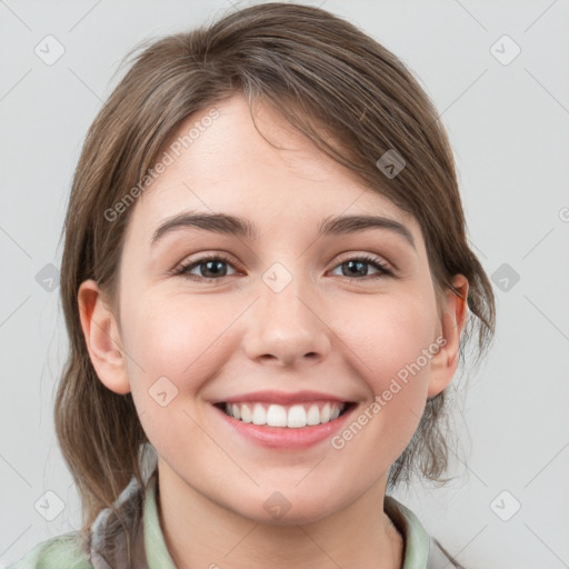 Joyful white young-adult female with medium  brown hair and grey eyes