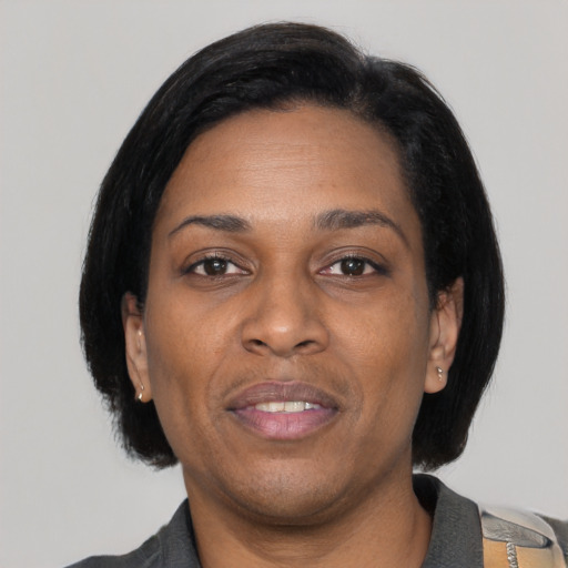 Joyful black adult female with medium  black hair and brown eyes