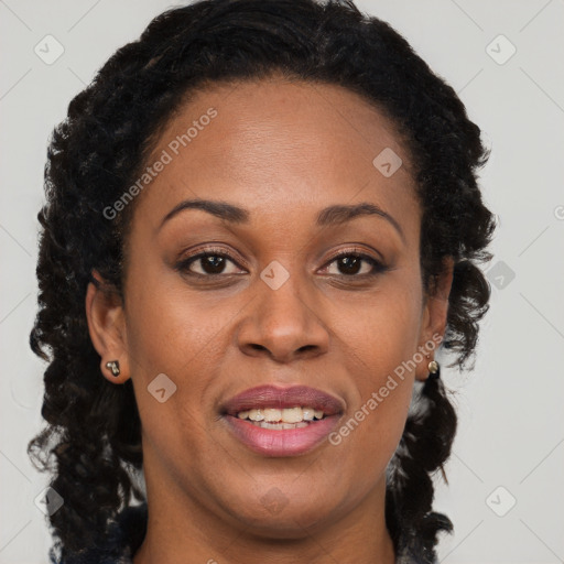 Joyful black adult female with long  brown hair and brown eyes