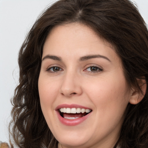 Joyful white young-adult female with long  brown hair and brown eyes