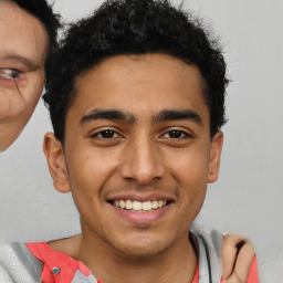 Joyful latino young-adult male with short  brown hair and brown eyes