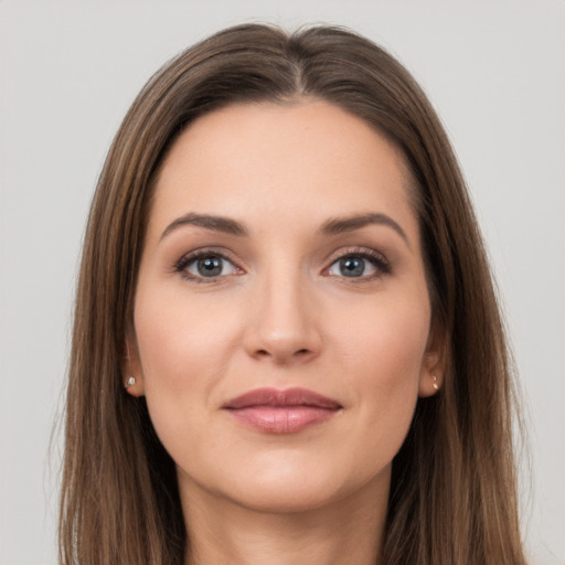 Joyful white young-adult female with long  brown hair and grey eyes