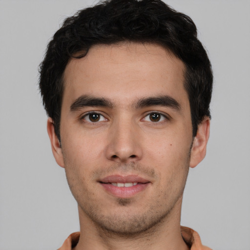 Joyful white young-adult male with short  black hair and brown eyes