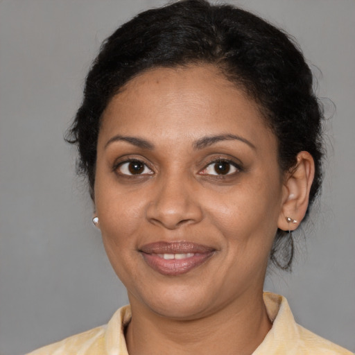 Joyful black young-adult female with medium  brown hair and brown eyes
