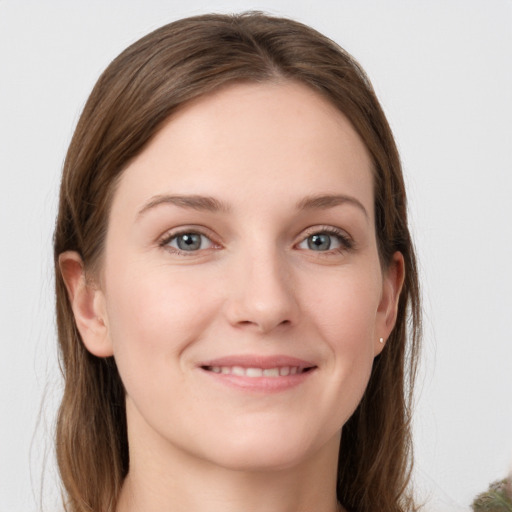 Joyful white young-adult female with long  brown hair and grey eyes