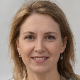 Joyful white adult female with medium  brown hair and grey eyes