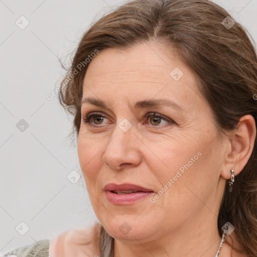 Joyful white adult female with medium  brown hair and brown eyes