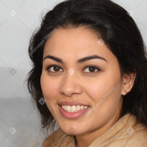 Joyful latino young-adult female with long  brown hair and brown eyes